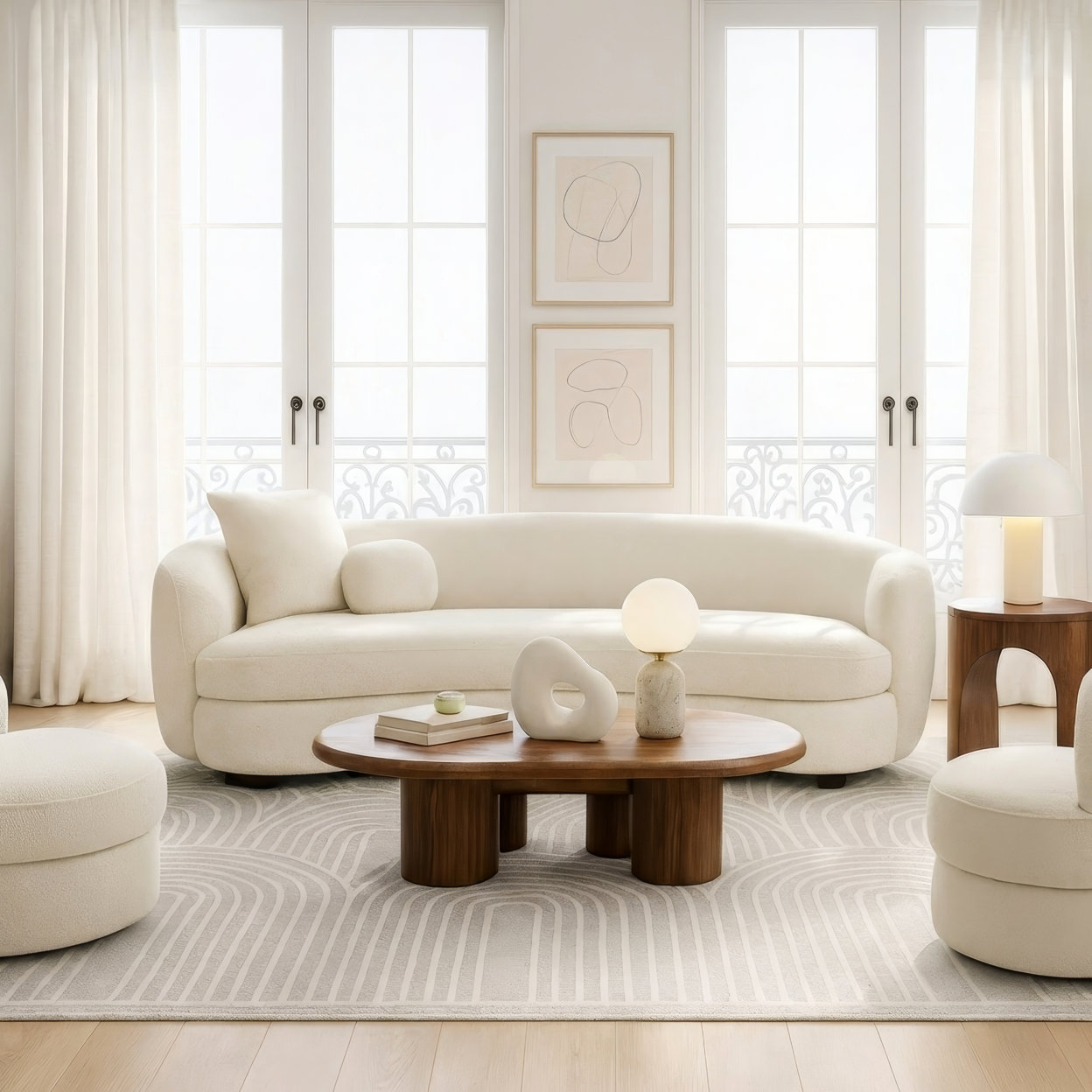 Living room with curved sofa and patterned rug.