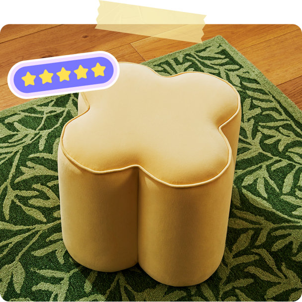 Yellow flower-shaped ottoman on a green leaf-patterned area rug